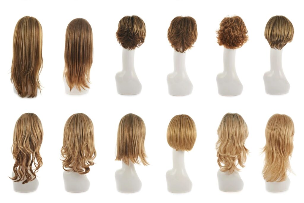selection of wigs on mannequin heads